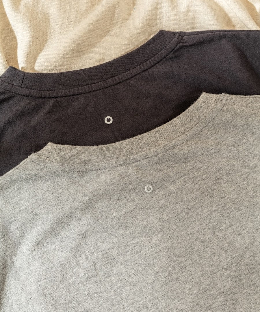 Close-up of a gray and black shirt with button details.