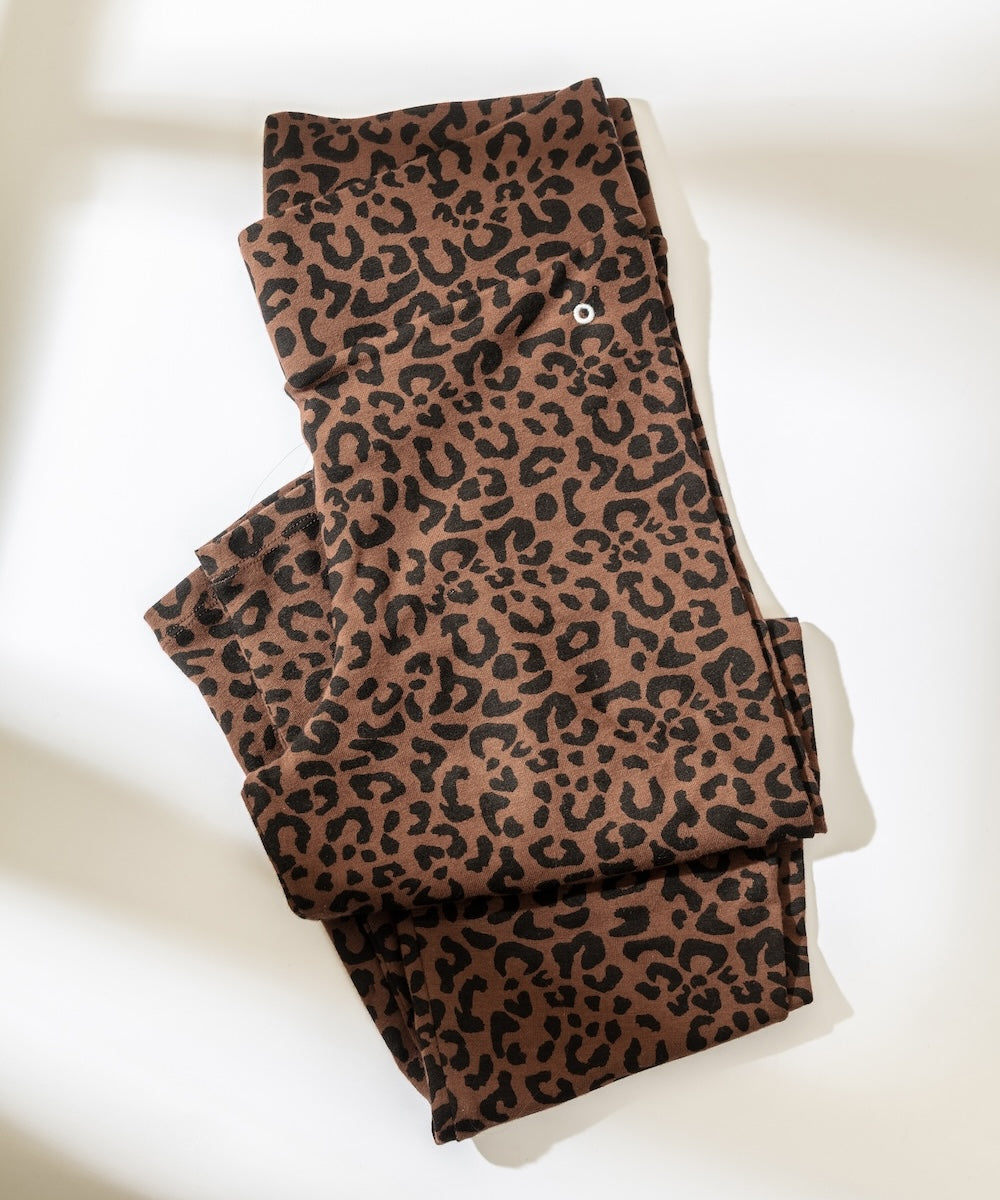 Folded brown leopard print fabric on a white background