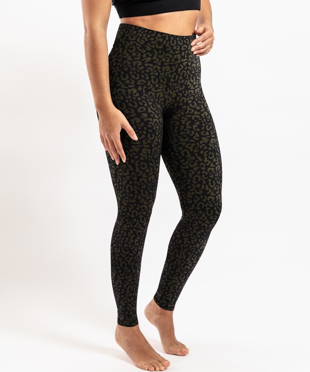 Person wearing black patterned leggings on a white background